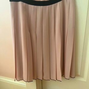 Below the knee, classic pleated skirt